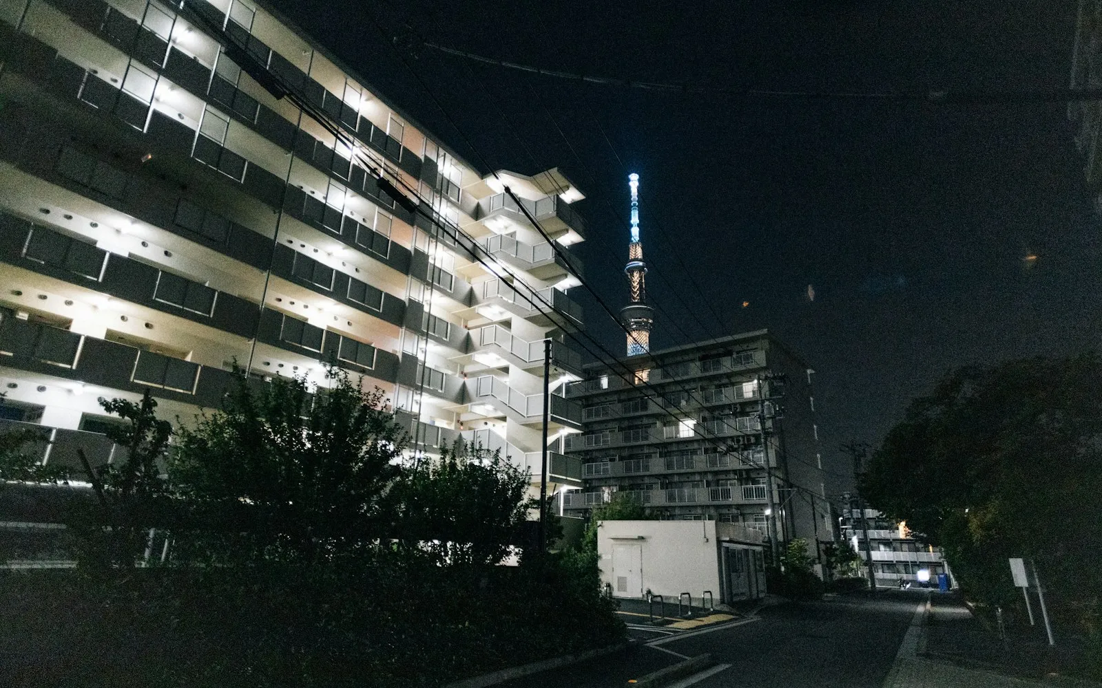 Illuminated apartment buildings with Tokyo Skytree in the distance