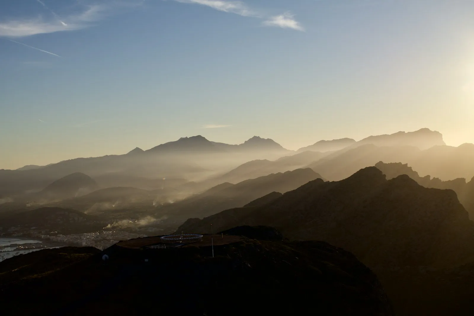 Sunlight breaking over a distant mountain range